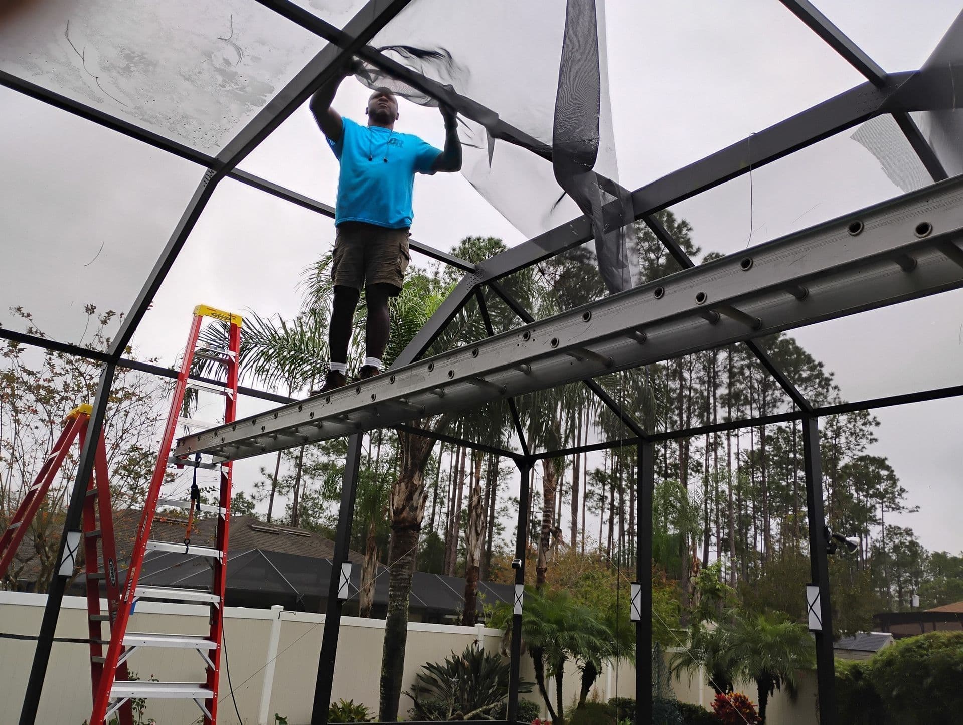 Demetrius, owner of D.R. Screening, installing pool cage screens in Palm Coast FL